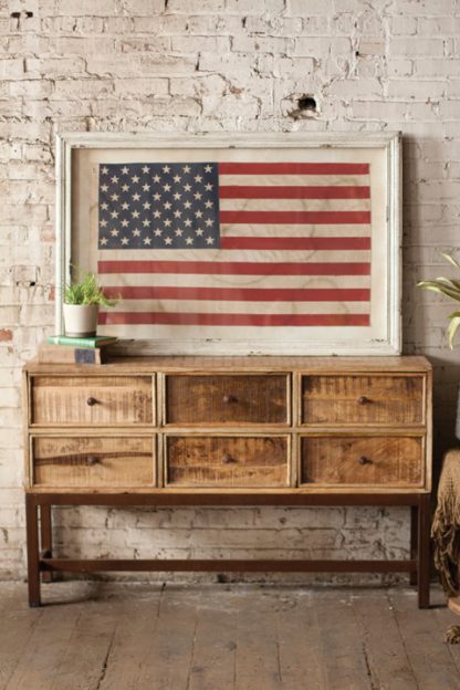 large framed american flag under glass