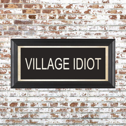 VILLAGE IDIOT Framed Print